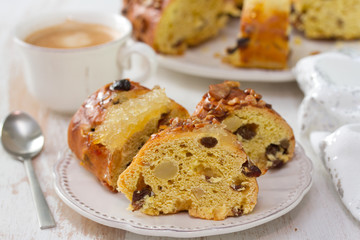 Christmas portuguese cake with dry fruits on white plate with cup of coffee