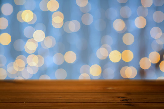 empty wooden table with christmas golden lights