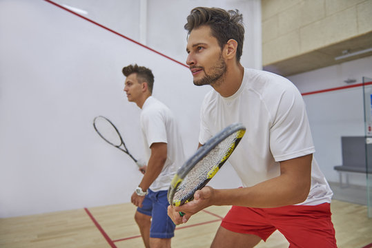 Very pensive men on the squash court.