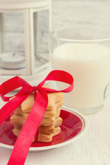 Plate with cookies, tied with a ribbon, a gift for Santa and a g