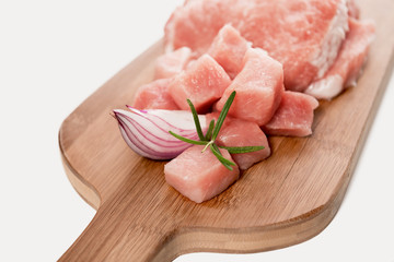 Fresh raw sliced pork meat is ready for preparation with rosemar