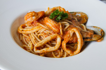 spaghetti sea food on white plate.