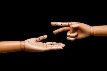 Two hands play rock, paper, scissors. Isolated on black background.