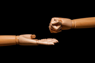 Two-handed wooden play rock, paper and scissors. On black background.