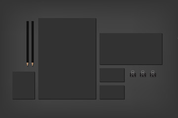 Black brand elements on dark with business cards and envelope.