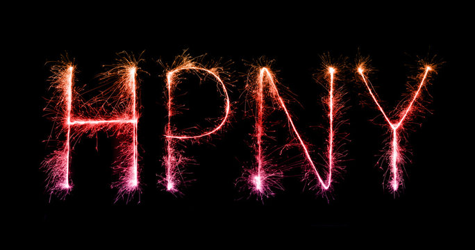 Happy New Year made of sparkles firework at night