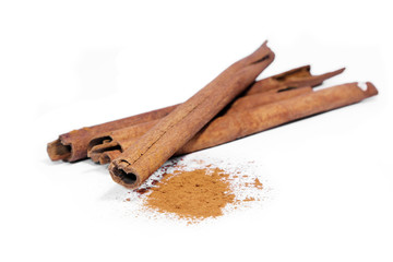 Cinnamon sticks and powder on white background.