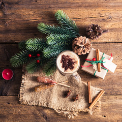 Cocoa on a wooden table with Christmas decorations, branches, sp