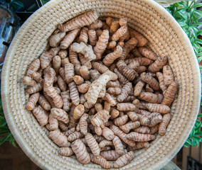 Basket with heap of turmeric roots