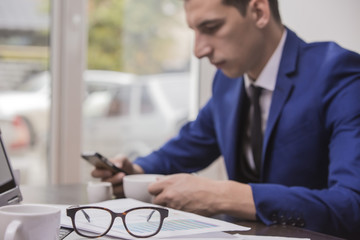 young businessman works sitting in a cafe