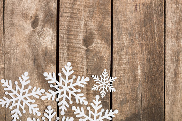 Decorative snowflakes on wooden background