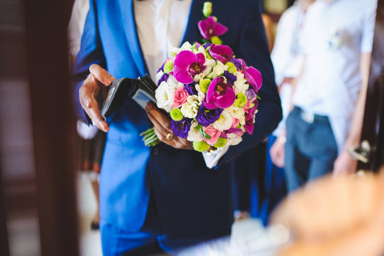Groom with Flowers and Wallet