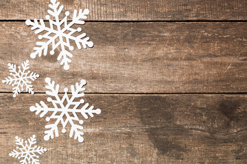 Decorative snowflakes on wooden background