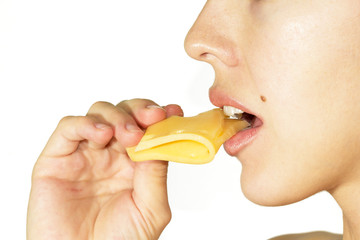 Young beautiful woman eating cheese. White background