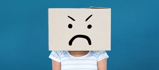 Composite image of depressed woman with box over head