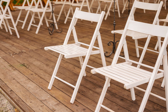 Group of white chairs in the garden 