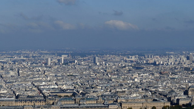 Panoramic footage in 4k with Paris from Montparnasse tower. Aerial view including Louvre Museum and different historical and commercial buildings.