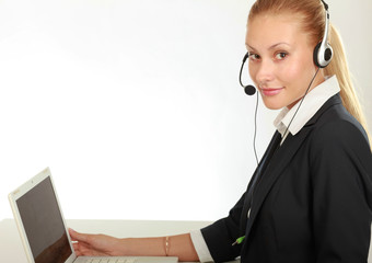 Female call center operator with headphone browsing on her computer