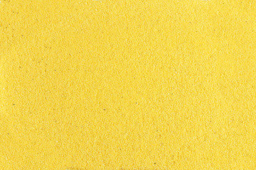 Background of yellow, coarse sand.