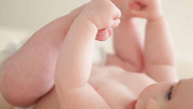 little baby playing with the feet