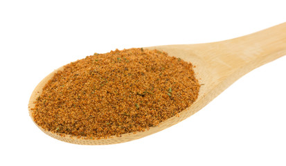 Wood spoon filled with dry chipotle pepper marinade ingredients