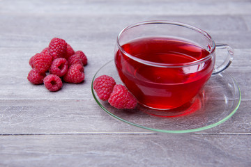 reshly brewed tea in glass cup wooden background
