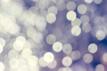 Fototapeta premium Light blurred background with white bokeh lights on it. Festive holiday theme with copyspace