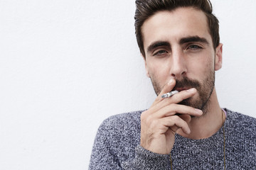 Portrait of young hipster smoking