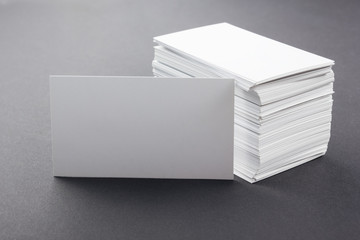 White blank business visit card, ticket, pass on grey black background