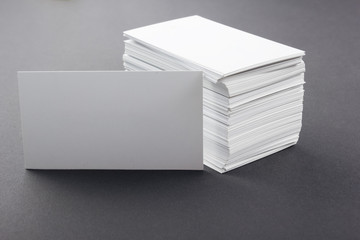 White blank business visit card, ticket, pass on grey black background