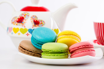 Collection of brightly colored French macarons on white backgrou