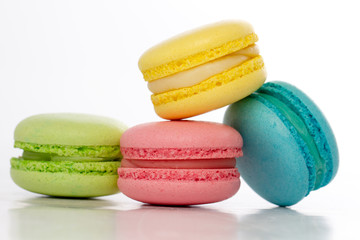 Collection of brightly colored French macarons on white backgrou