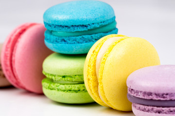 Collection of brightly colored French macarons on white backgrou