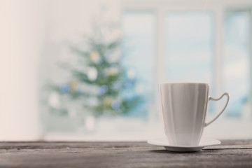 Obraz na płótnie Canvas white cup on background Christmas fir and window