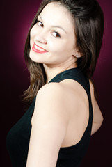 Fototapeta premium Smiling woman looking over shoulder