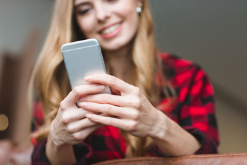 Fototapeta premium Content cheerful blonde girl using cellphone