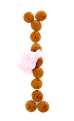 Ginger nuts, pepernoten, in the shape of letter I isolated on wh
