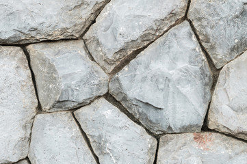 Closeup old stone wall in the garden texture background