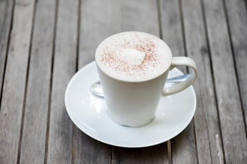 Hot chocolate in a white cup on table