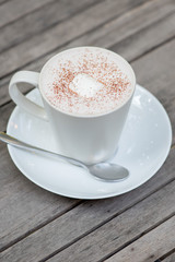 Hot chocolate in a white cup on table