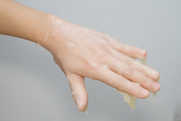 woman's hand bathing in paraffin or wax , Hand and nail spa