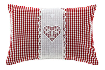 Closeup of a red gingham pillow with flake of Swiss stone pine inside, decorated with hand-made...