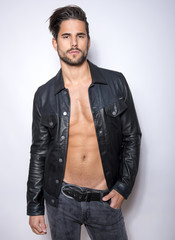 handsome young and fit man posing with open jacket