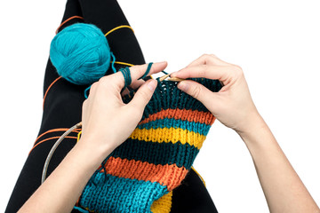 Knitting. Young woman knitting isolated on white background.