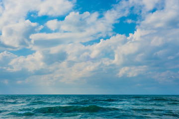 Naklejka na ściany i meble Sea background with cloudy sky.
