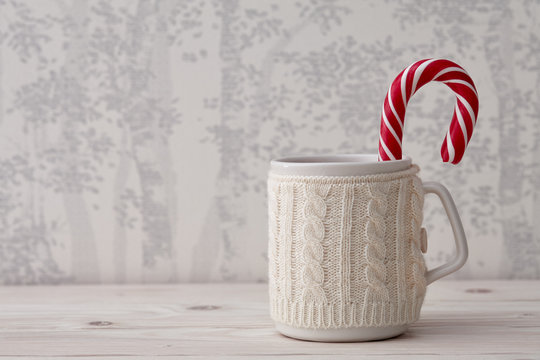 Knitted winter cup with candy cane