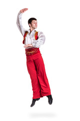 Jumping man wearing a toreador costume. Isolated on white in full length