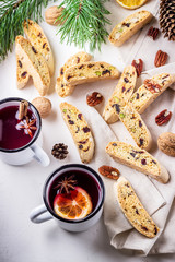 Two mugs of mulled wine  and italian biscotti cookies on wooden table.Style rustic.