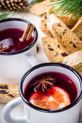 Two mugs of mulled wine  and italian biscotti cookies on wooden table.Style rustic.