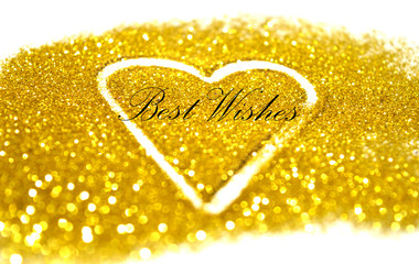 Text Best Wishes on blurry abstract heart of golden glitter on white background, can be used as greeting card